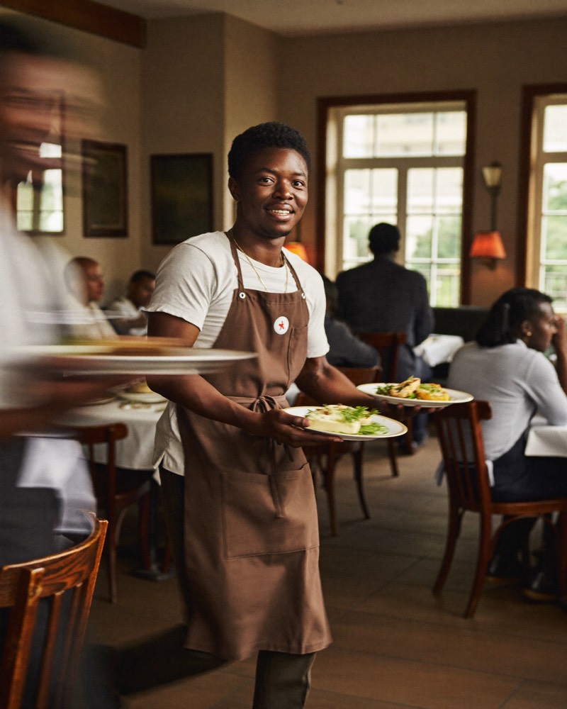 Waiter taking an order in a Kenyan restaurant